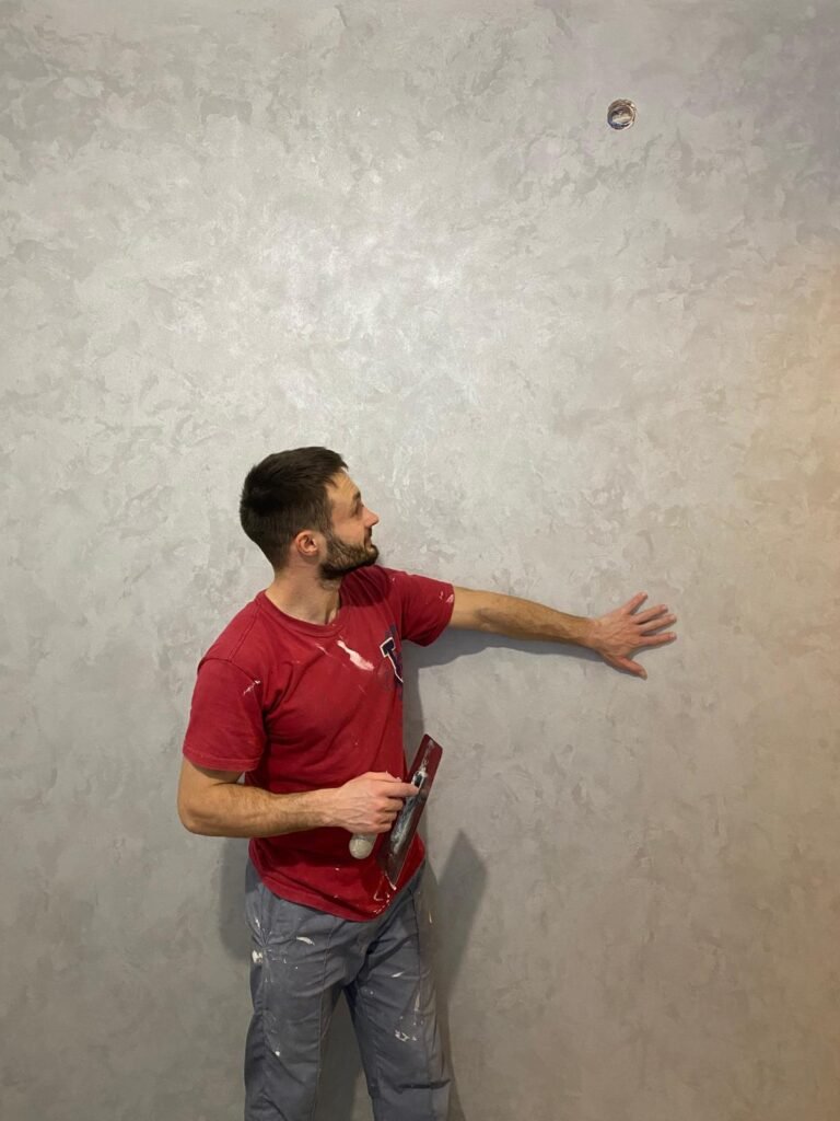 a man holding a clipboard and looking up at a wall